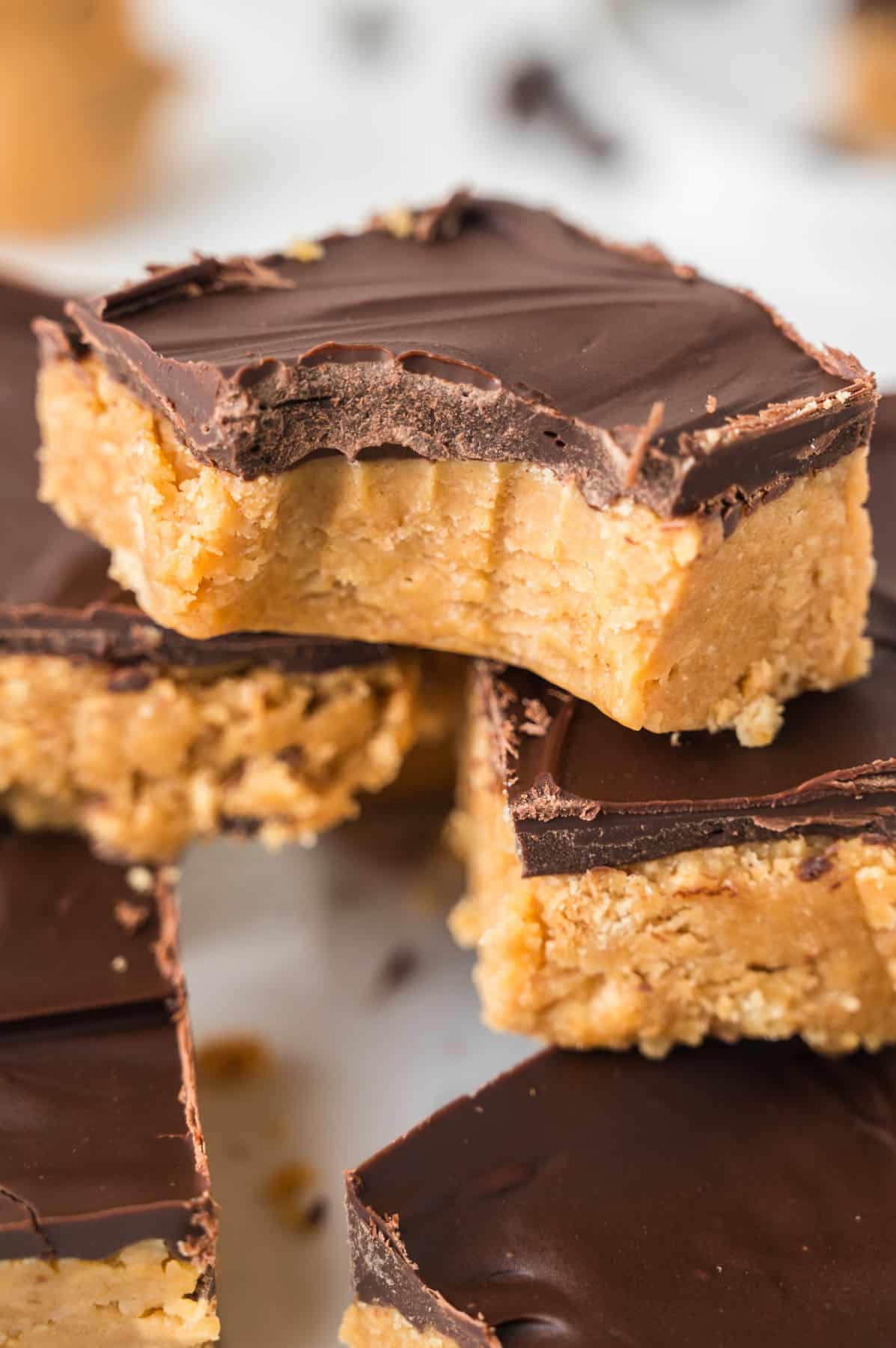 An image of a no-bake peanut butter square with a bite taken out of it.