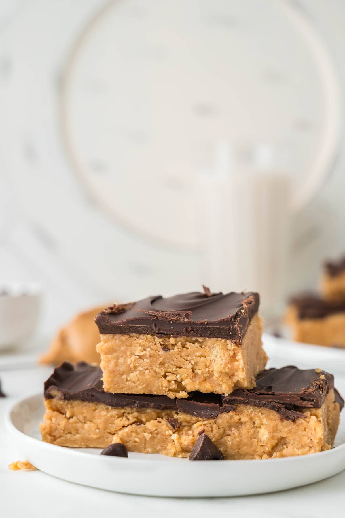 A stack of no-bake peanut butter bars on a white plate.