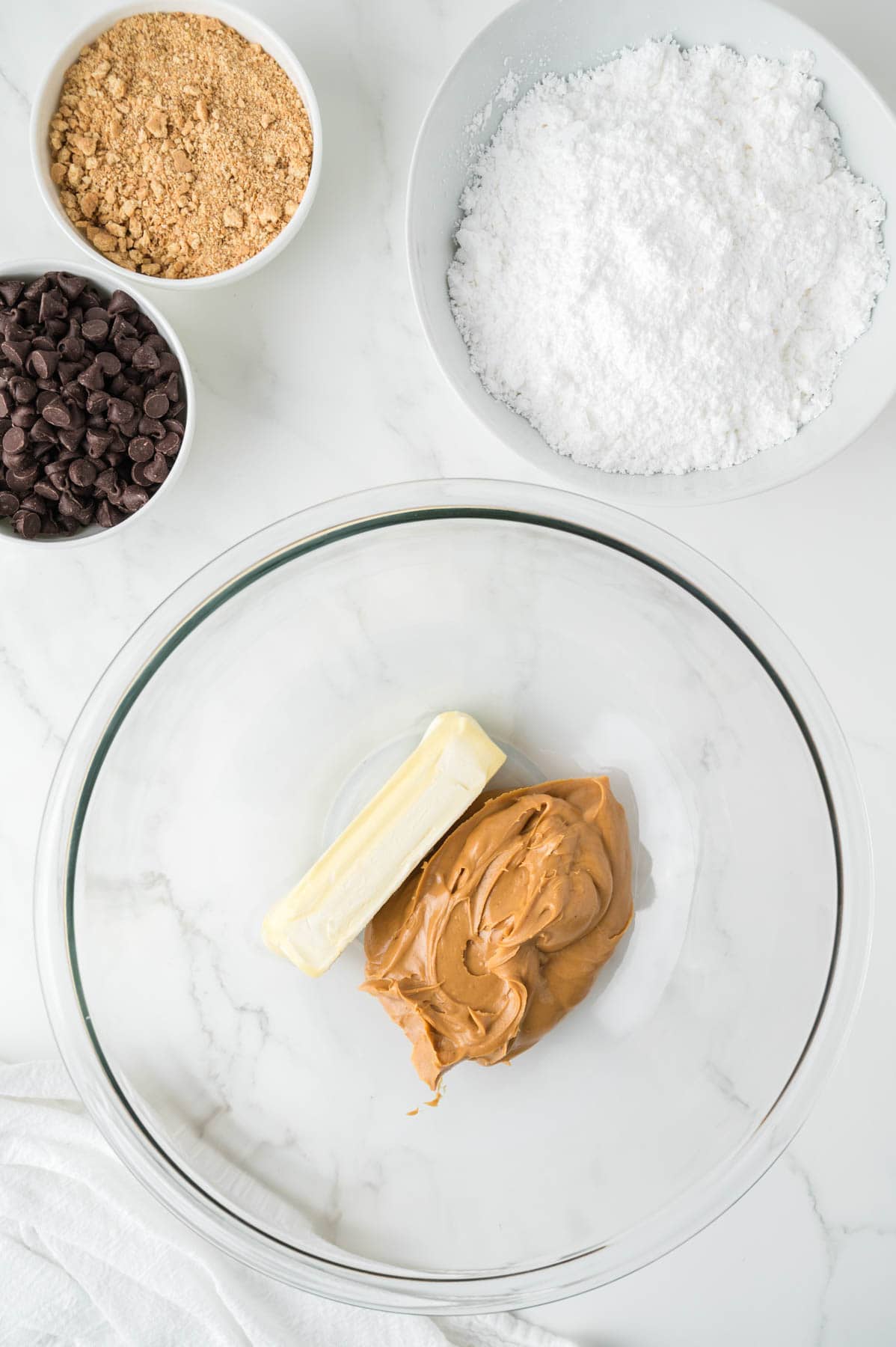 Combining softened butter and creamy peanut butter in a large mixing bowl.