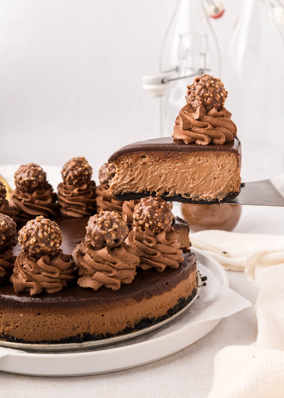 A slice of nutella cheesecake being lifted up with a spatula.