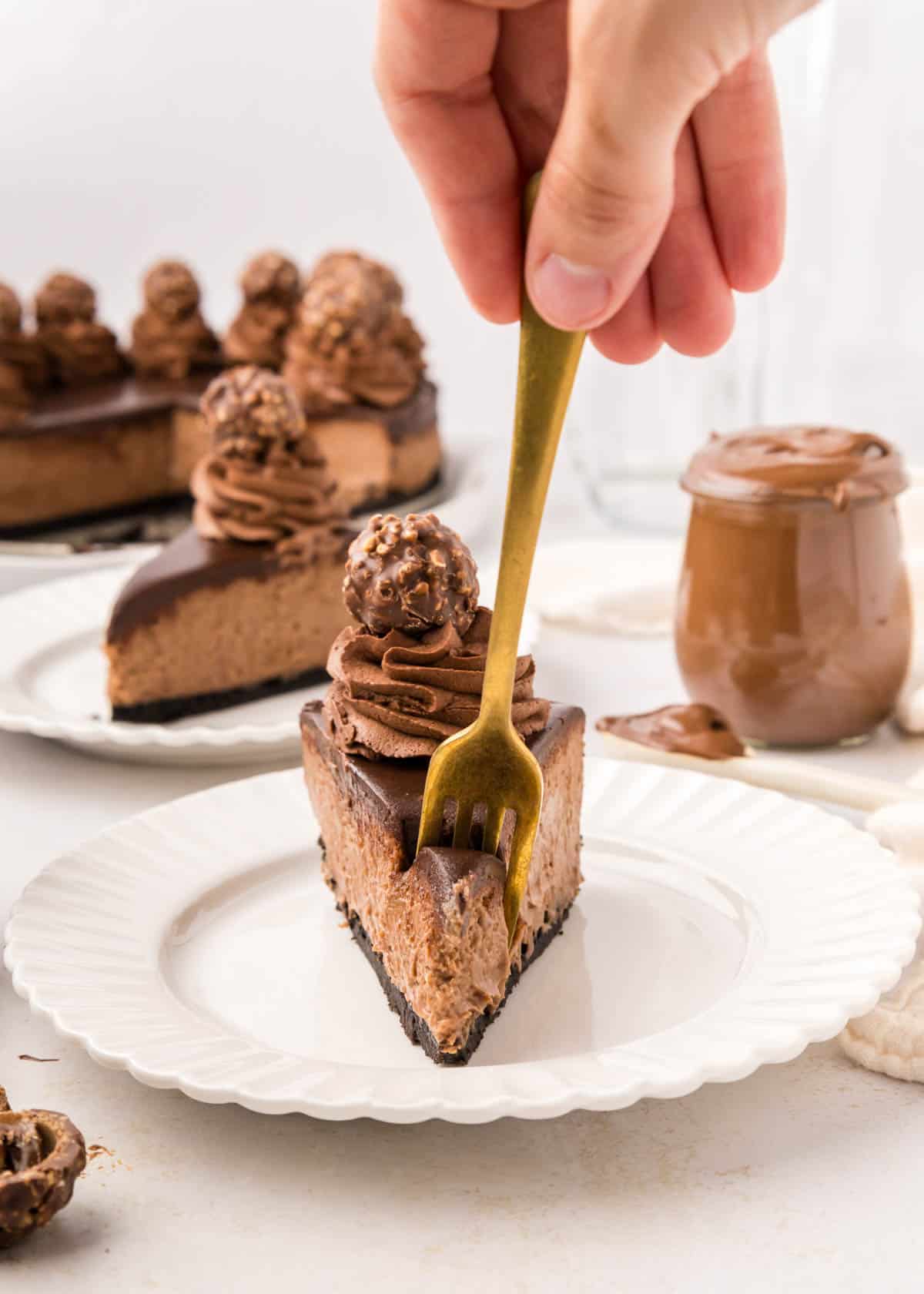 A fork being used to take a bite of Nutella cheesecake.