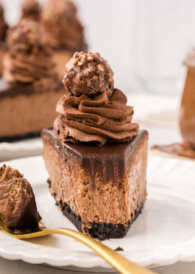 A close image of a slice of Nutella cheesecake with a bite taken out of it.