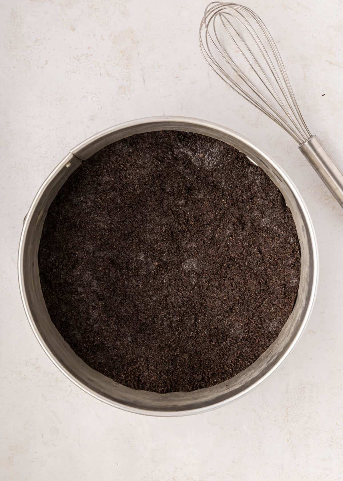 An Oreo cookie crust pressed into a springform pan.