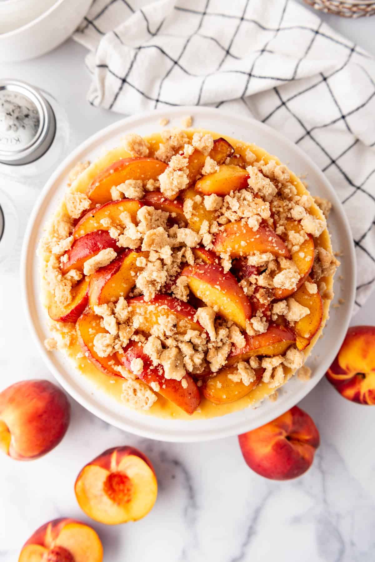 An overhead image of a baked peach cobbler cheesecake.