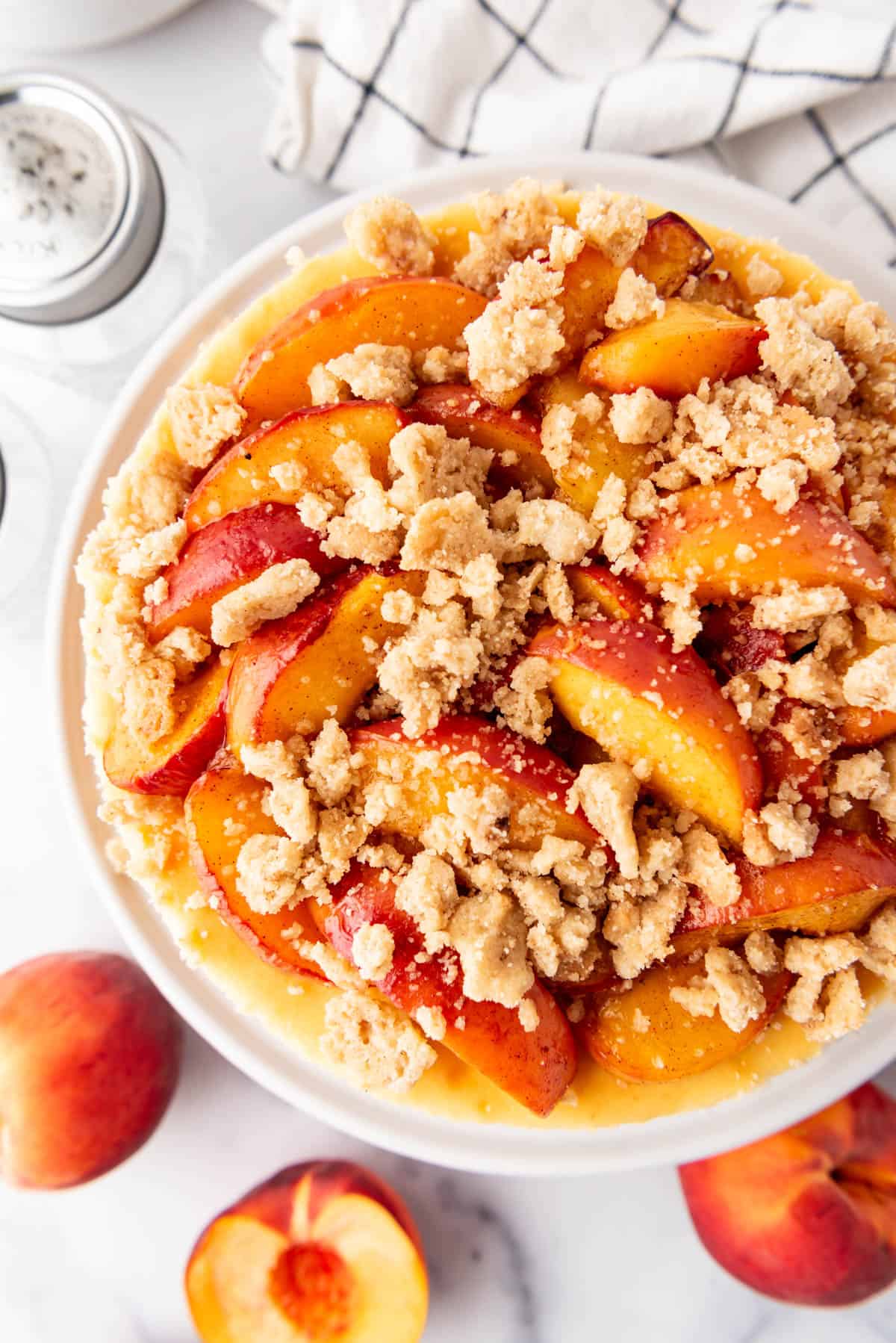 An overhead image of a cheesecake with peach topping.