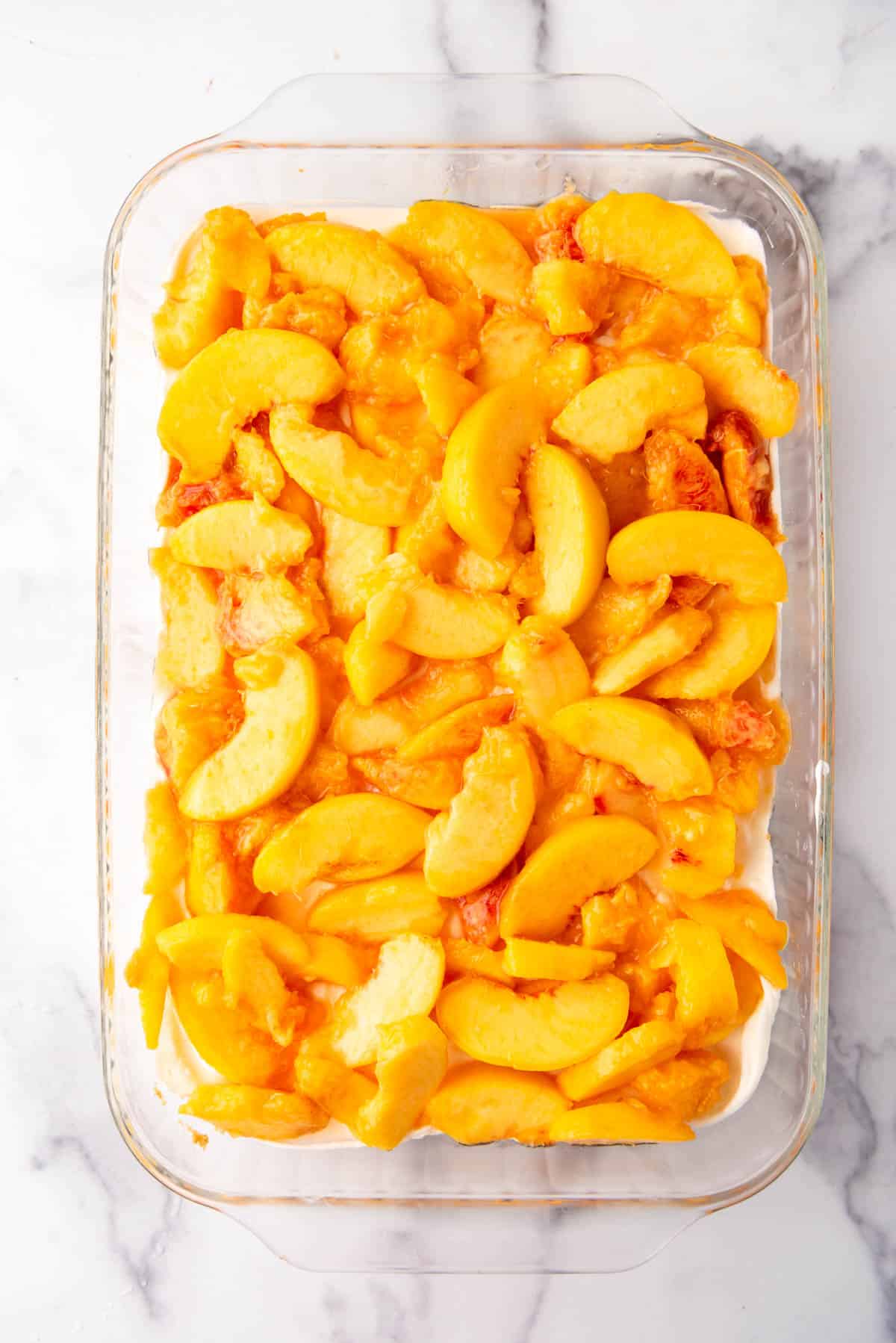 Sliced peaches spread over a creamy filling.