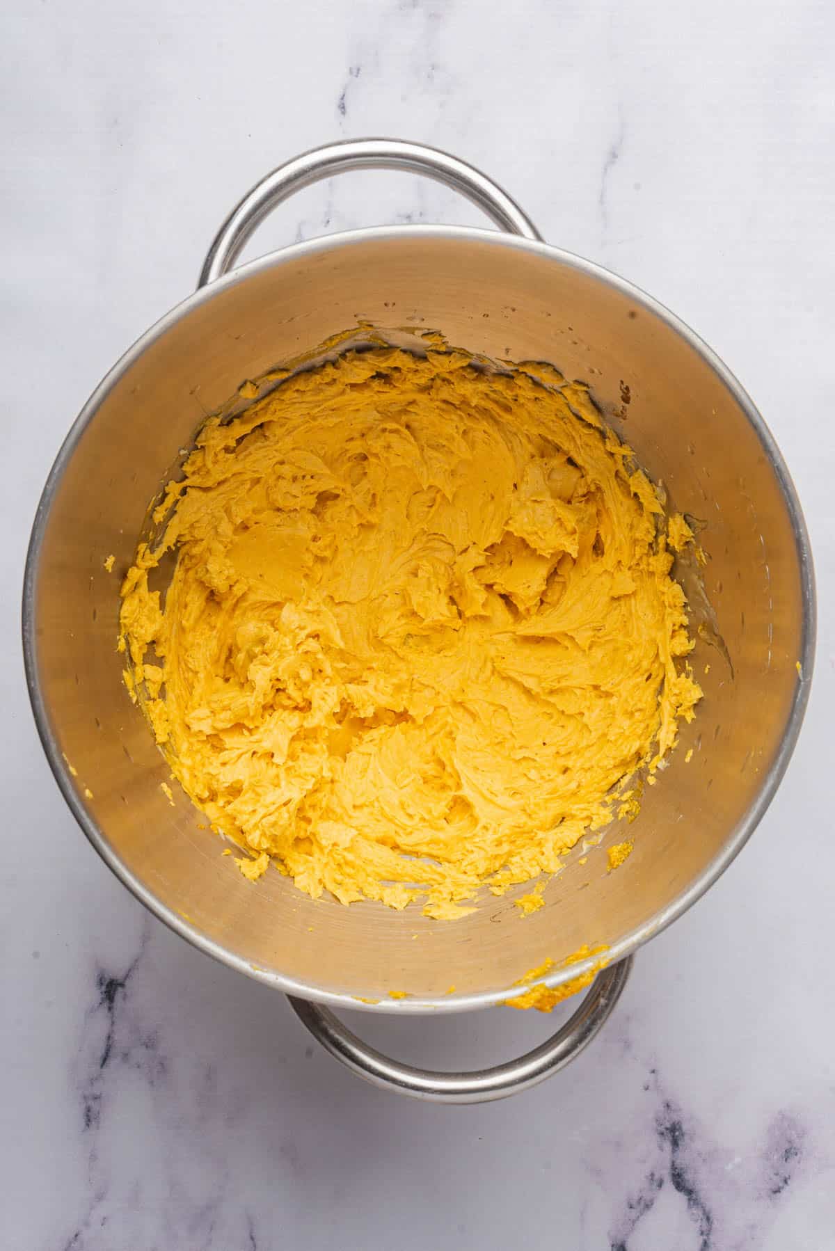 Whipped pumpkin butter in a large mixing bowl.