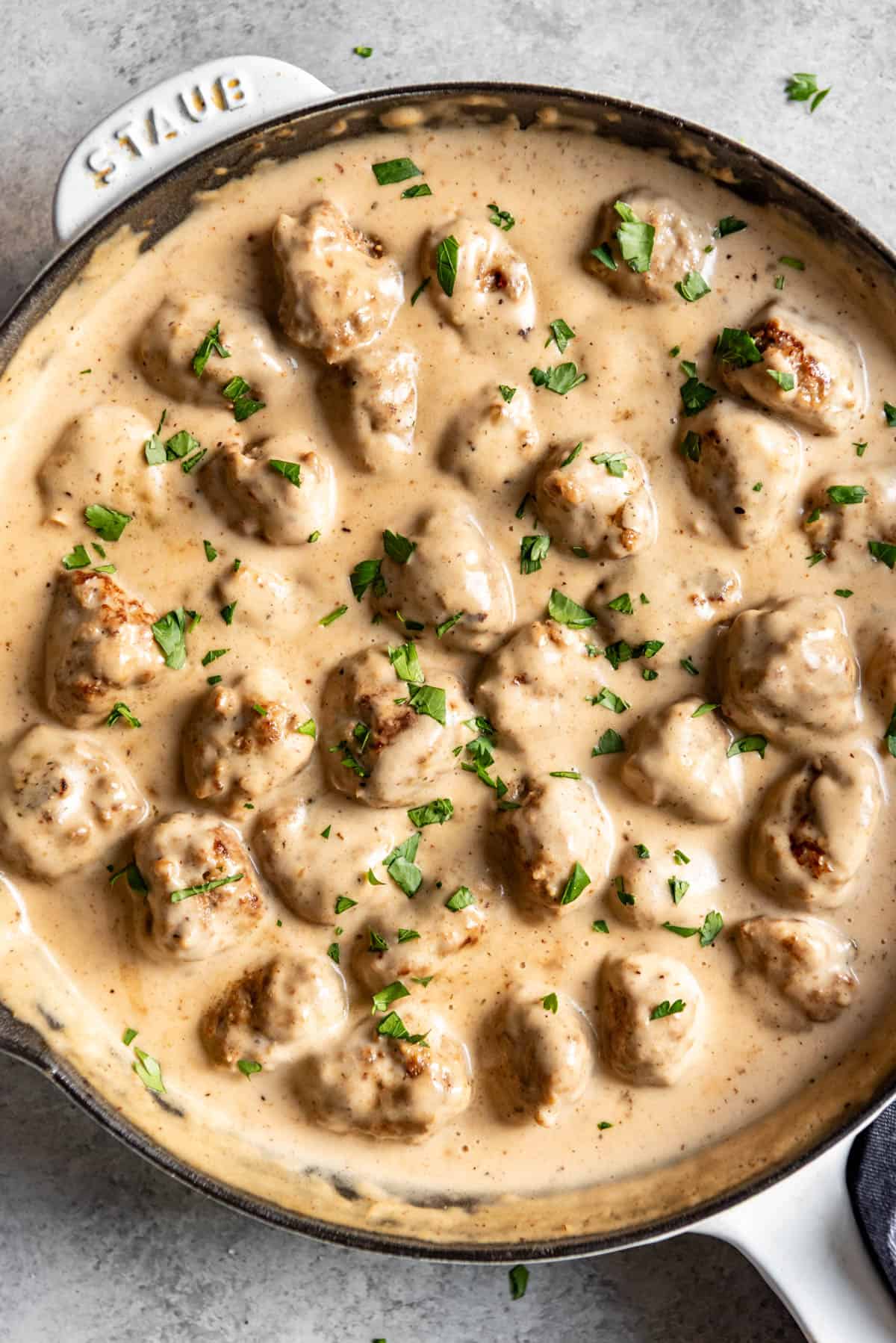 An image of homemade Swedish meatballs in a creamy gravy.