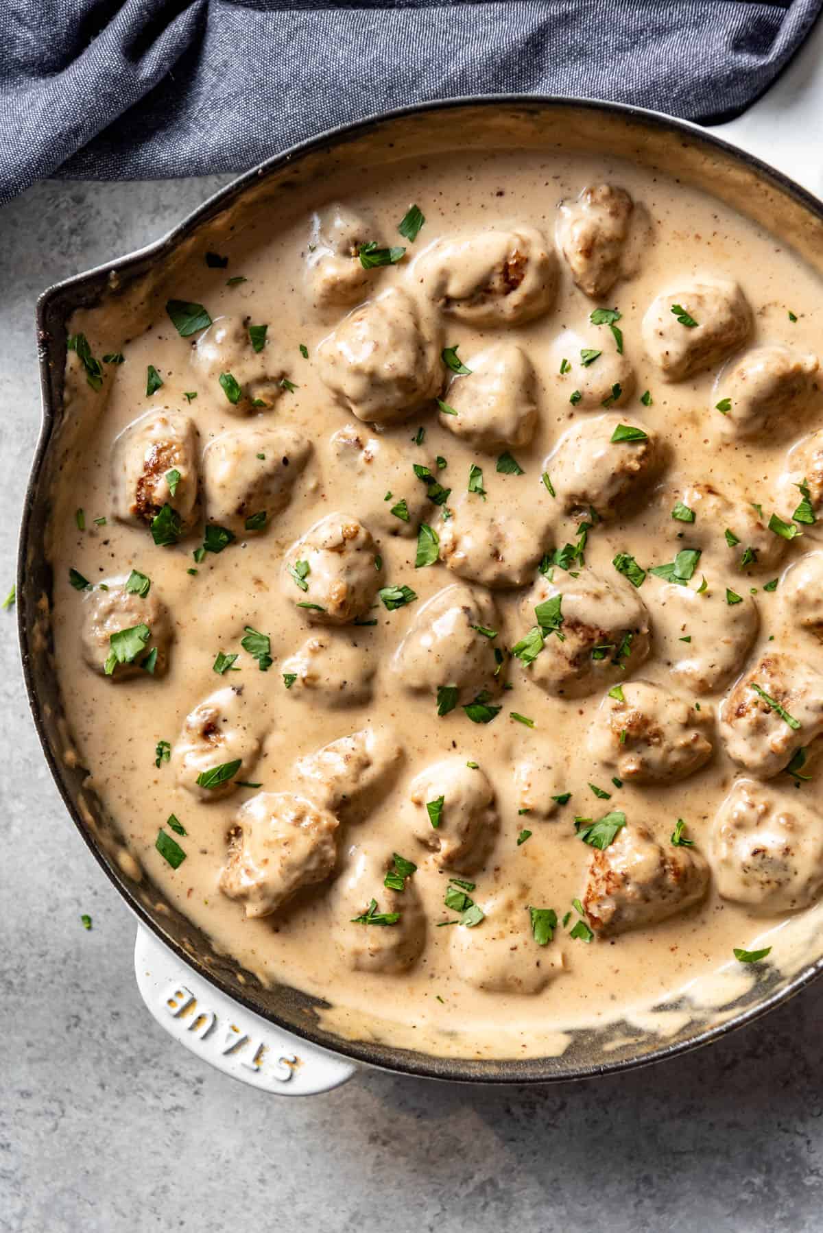 An overhead image of a pan of swedish meatballs in creamy sauce.