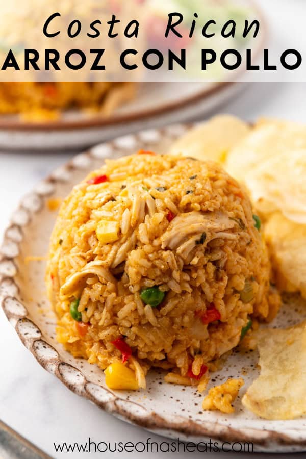 A serving of arroz con pollo on a plate with potato chips with text overlay.