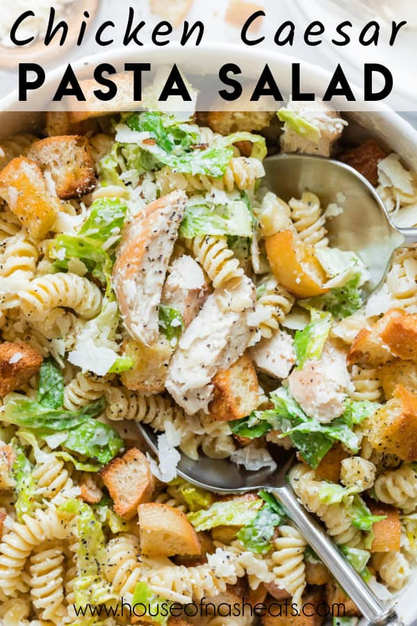 An overhead closeup image of a chicken caesar pasta salad with a serving spoon in it with text overlay.