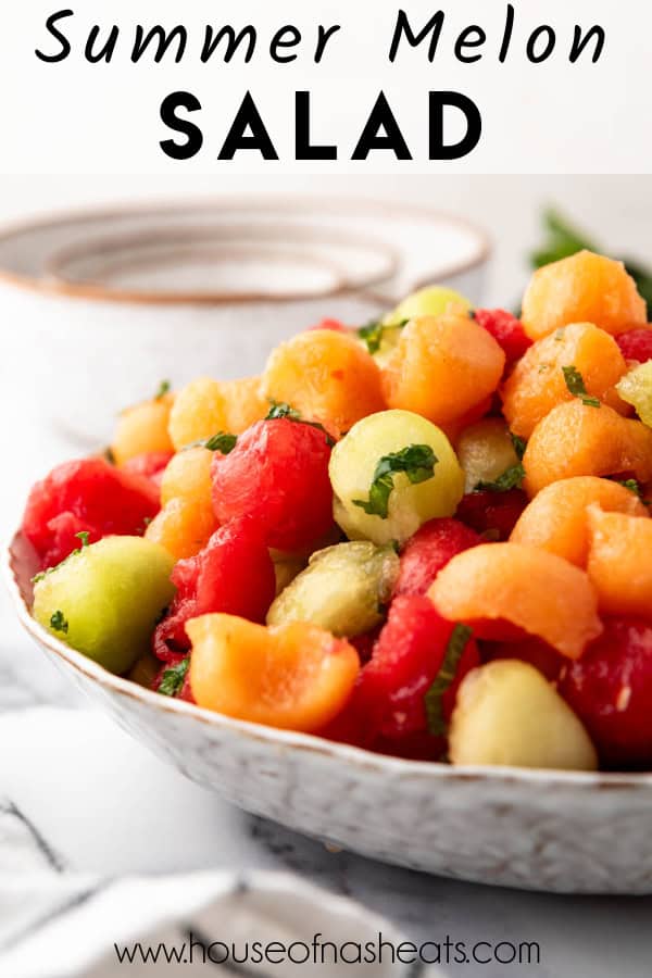 A large bowl of summer melon salad with text overlay.