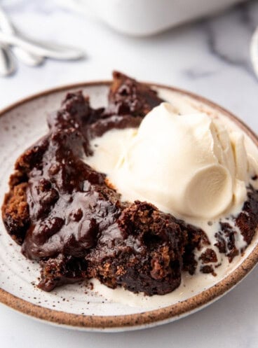 An image of a plate of chocolate cobbler with ice cream.