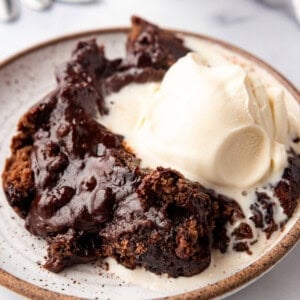 An image of a plate of chocolate cobbler with ice cream.