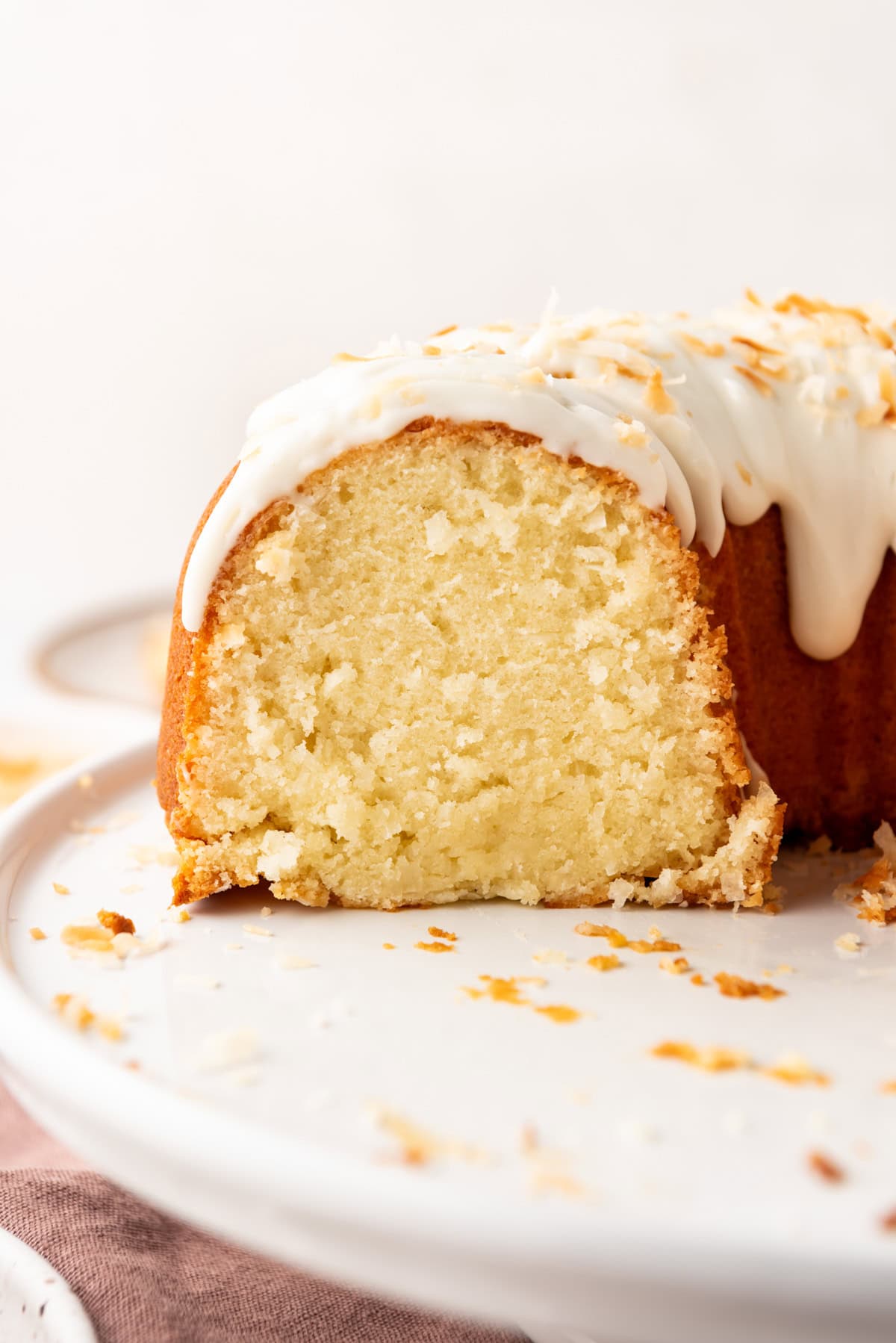 A cross-section view of a sliced coconut bundt cake.