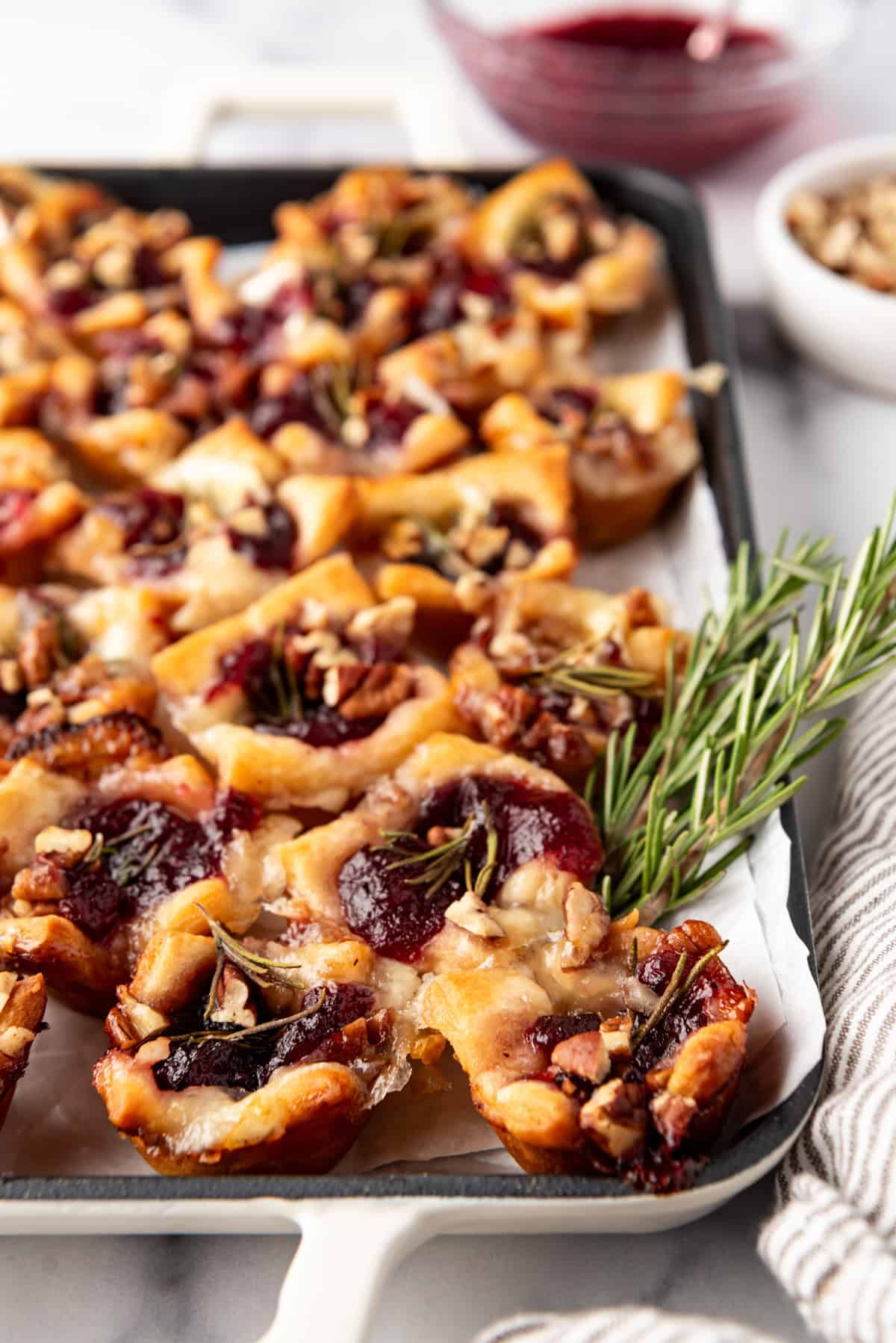 A side view of cranberry brie bites on a serving platter.