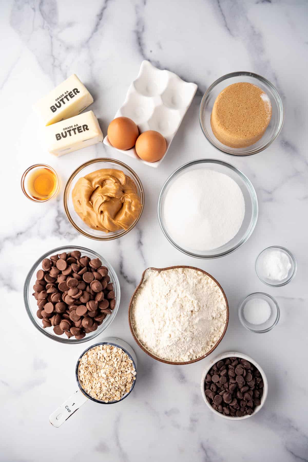 Ingredients for making oatmeal peanut butter chocolate chip cookies.