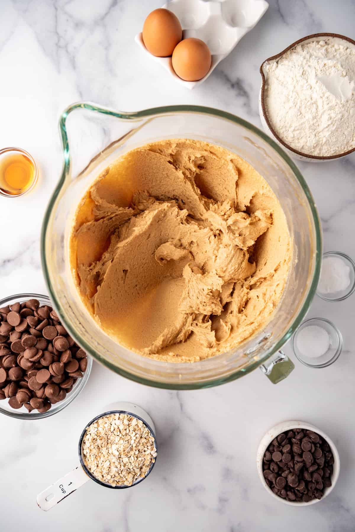 Creamed ingredients in a bowl surrounded by more ingredients.