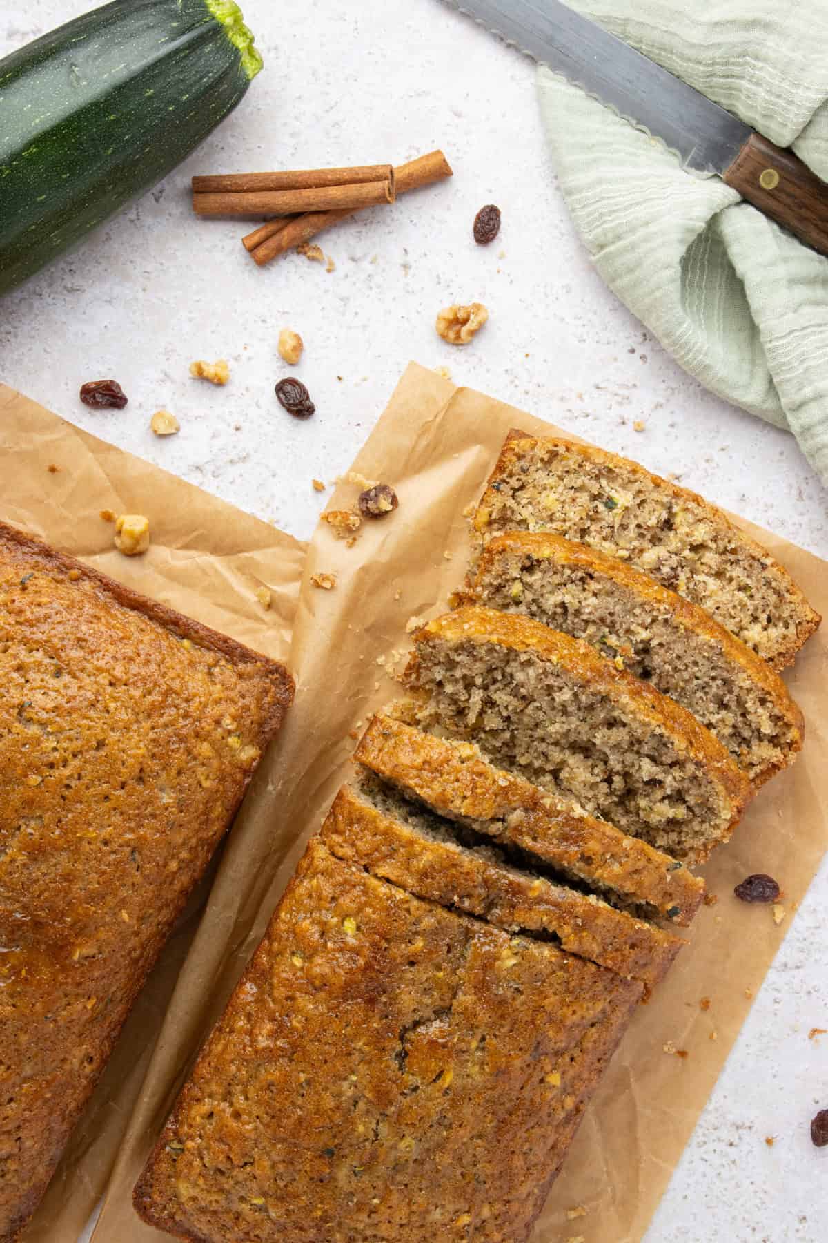 Two loaves of pineapple zucchini bread with one loaf sliced.