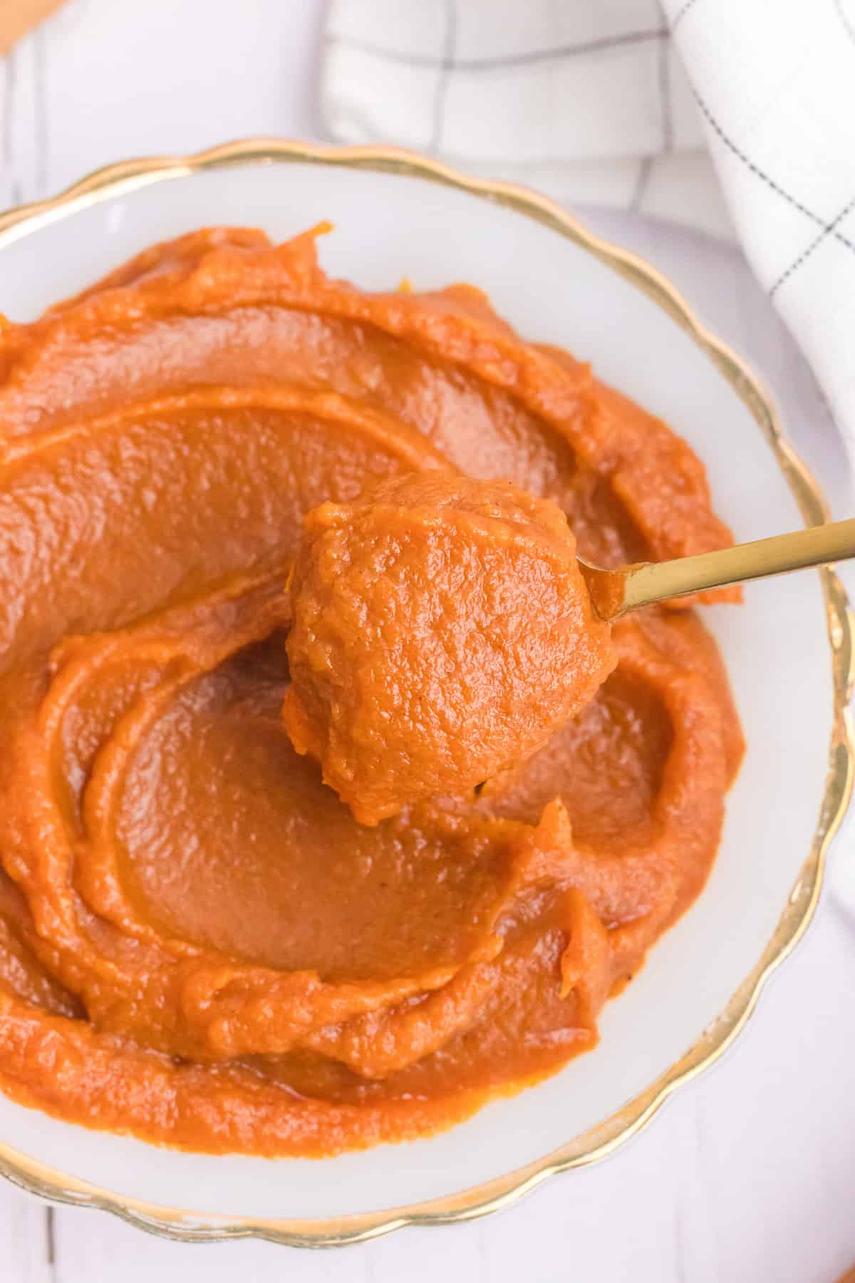 An image of pumpkin butter with a spoon in it.