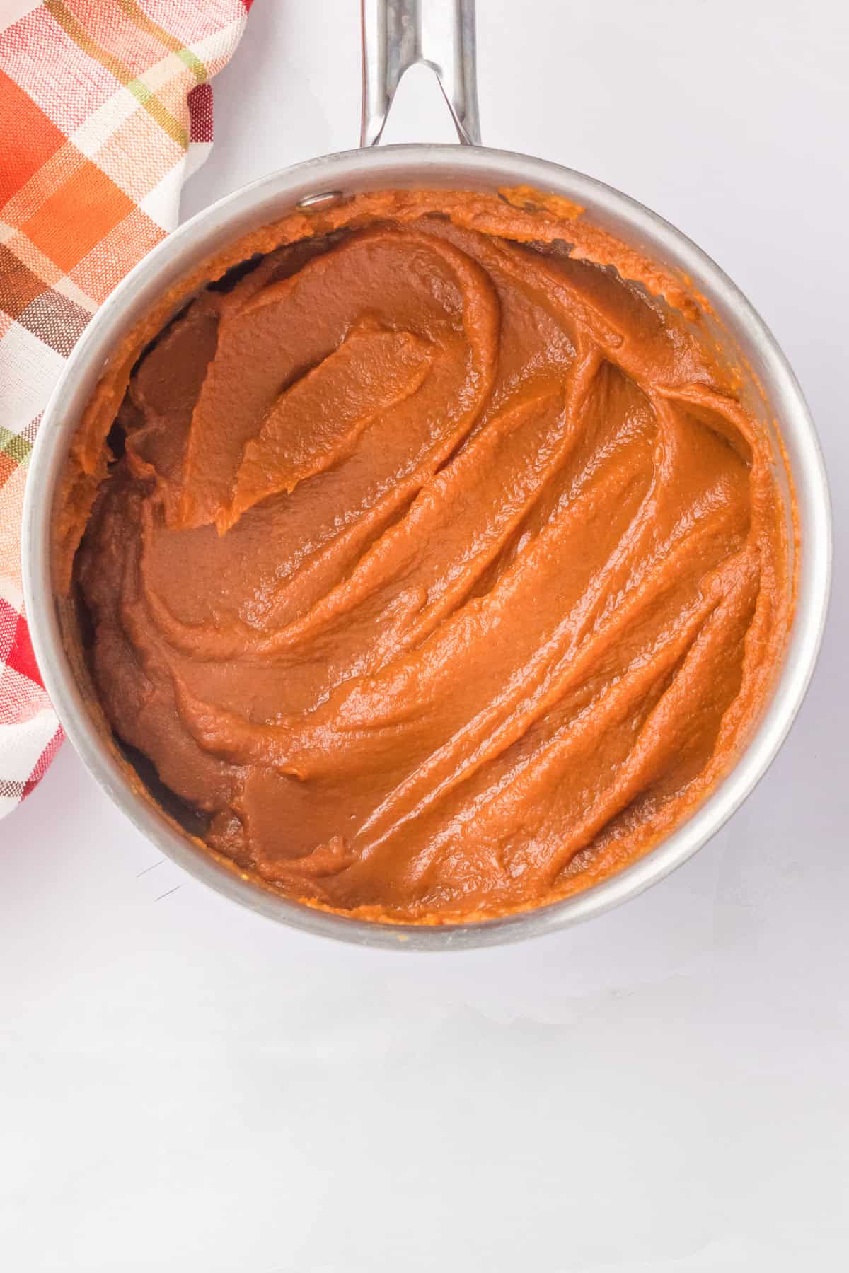 Cooked pumpkin butter in a saucepan.