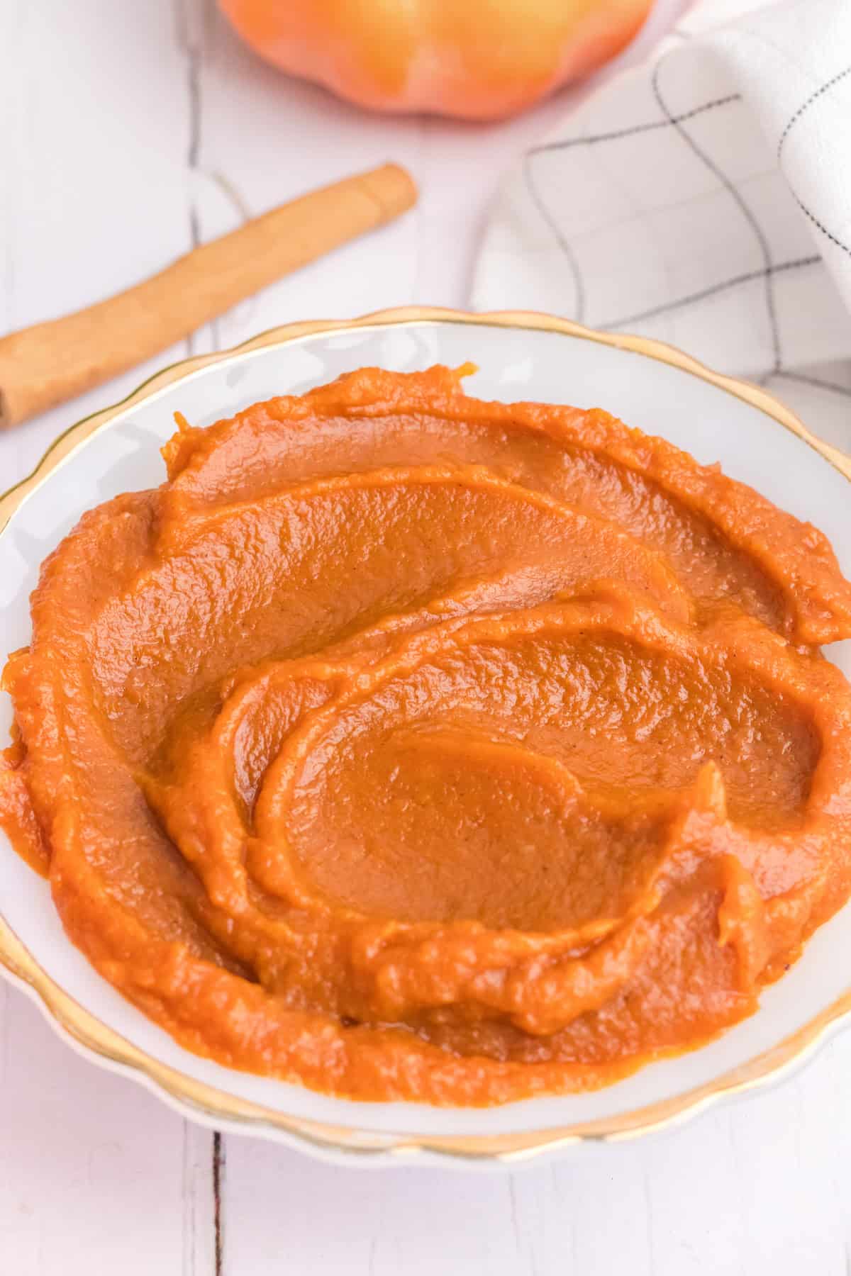 A side angle view of a bowl of homemade pumpkin butter.