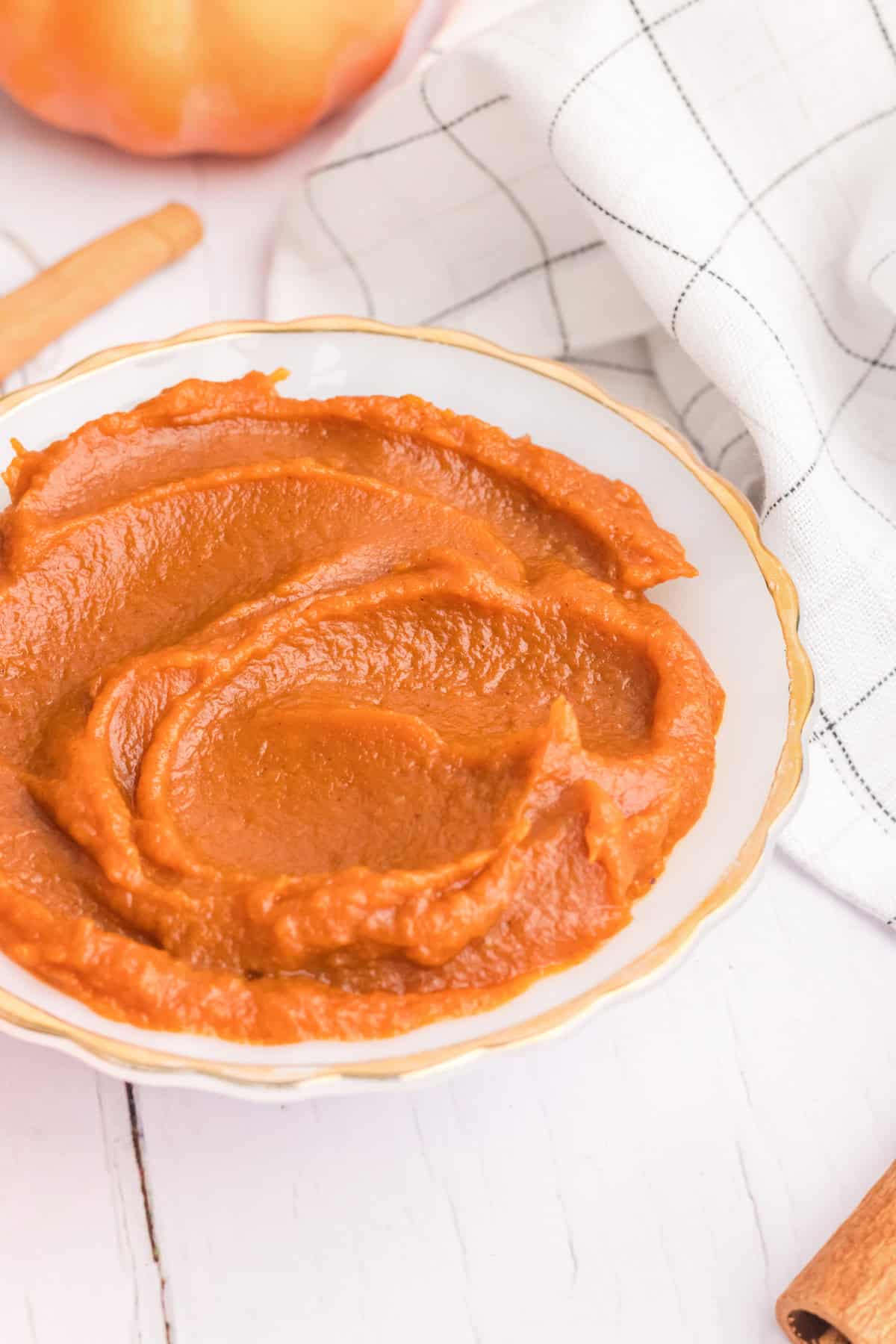 A side angle view of a bowl of homemade pumpkin butter.