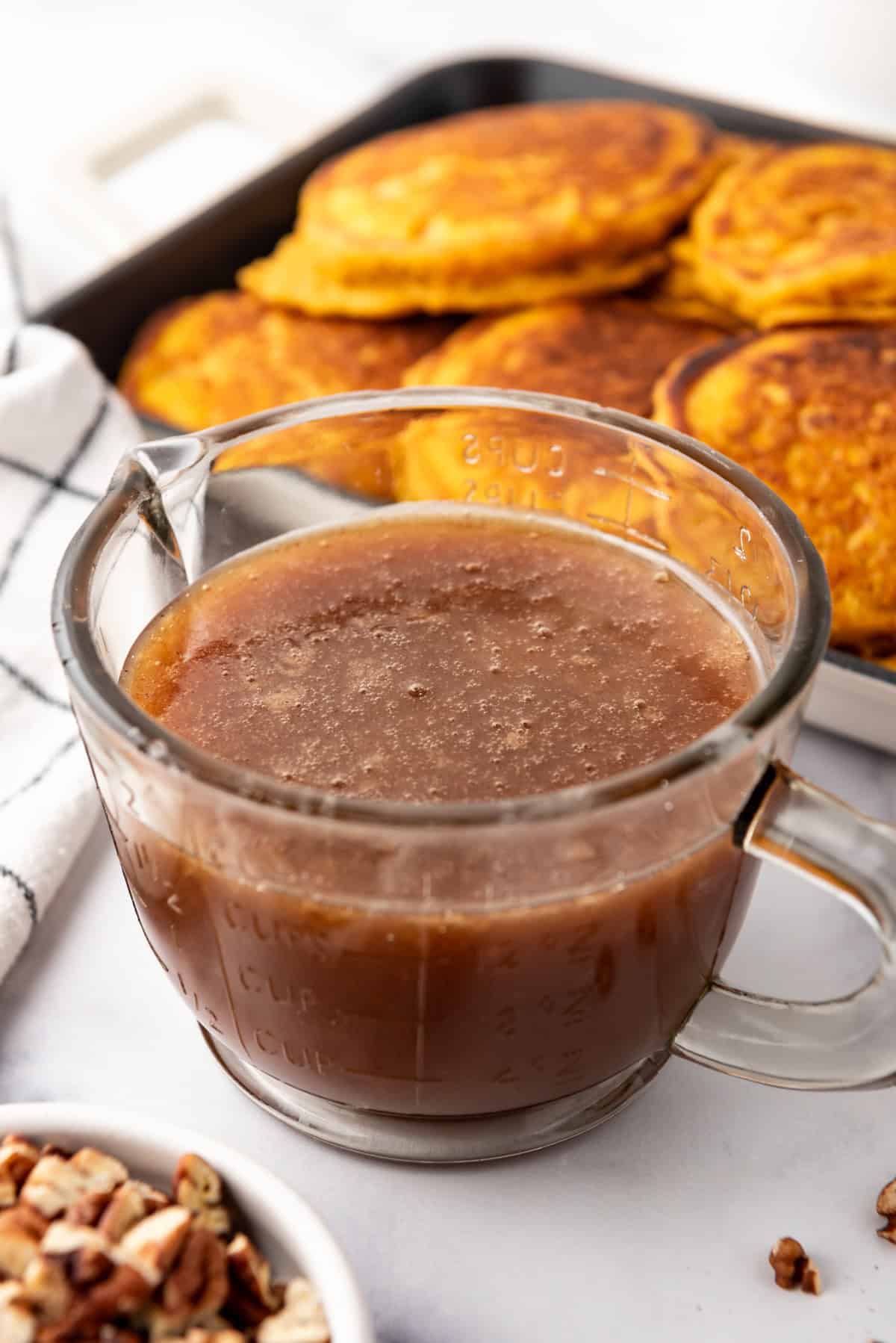 Creamy cinnamon syrup in a glass container.