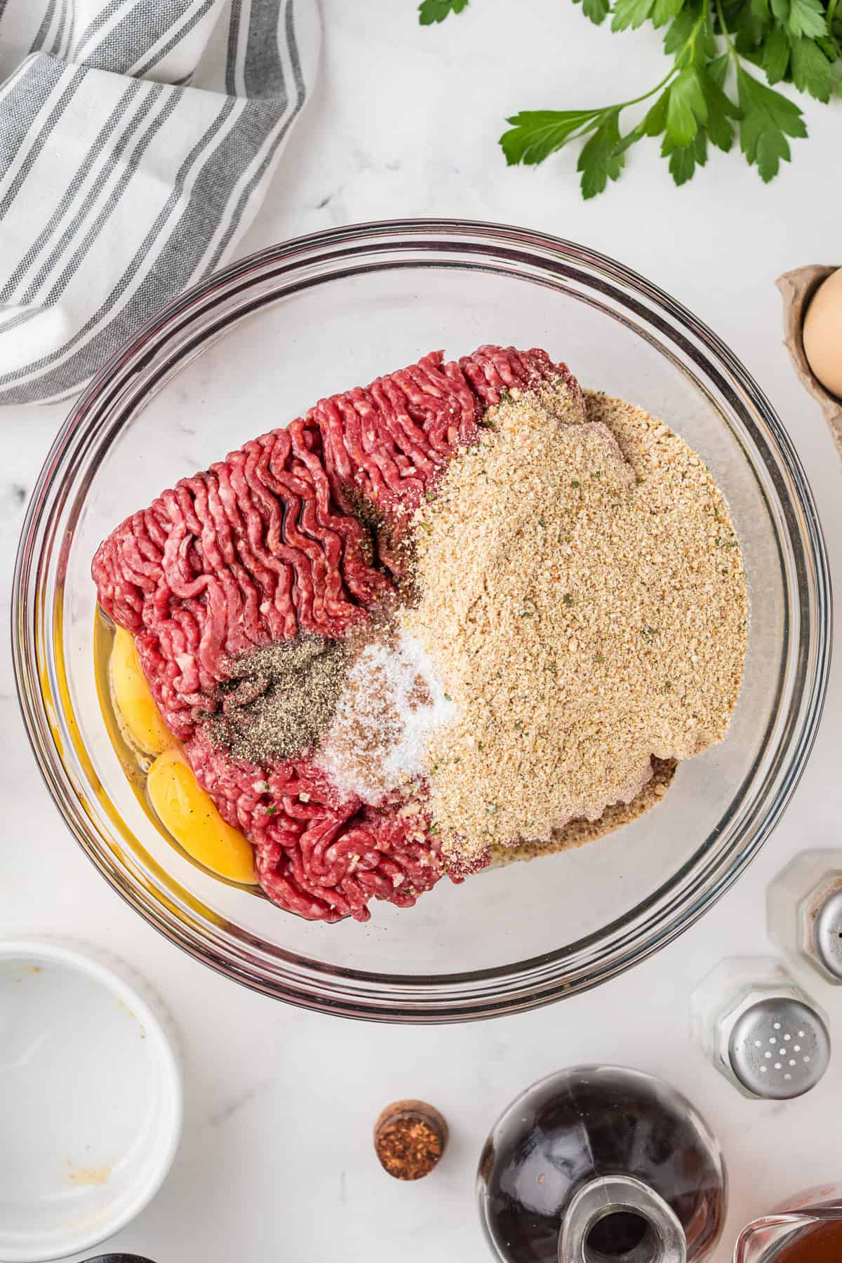 An overhead image of the ingredients for salisbury steaks combined in a large mixing bowl.