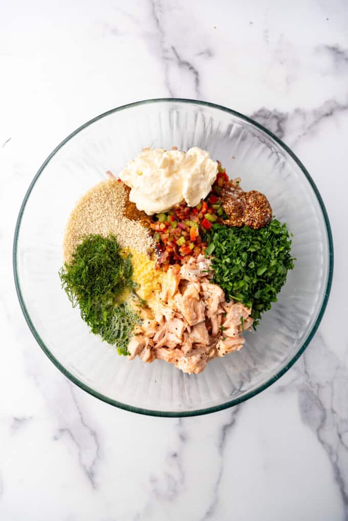 Ingredients for Salmon Cake patty mixture in a glass mixing bowl.