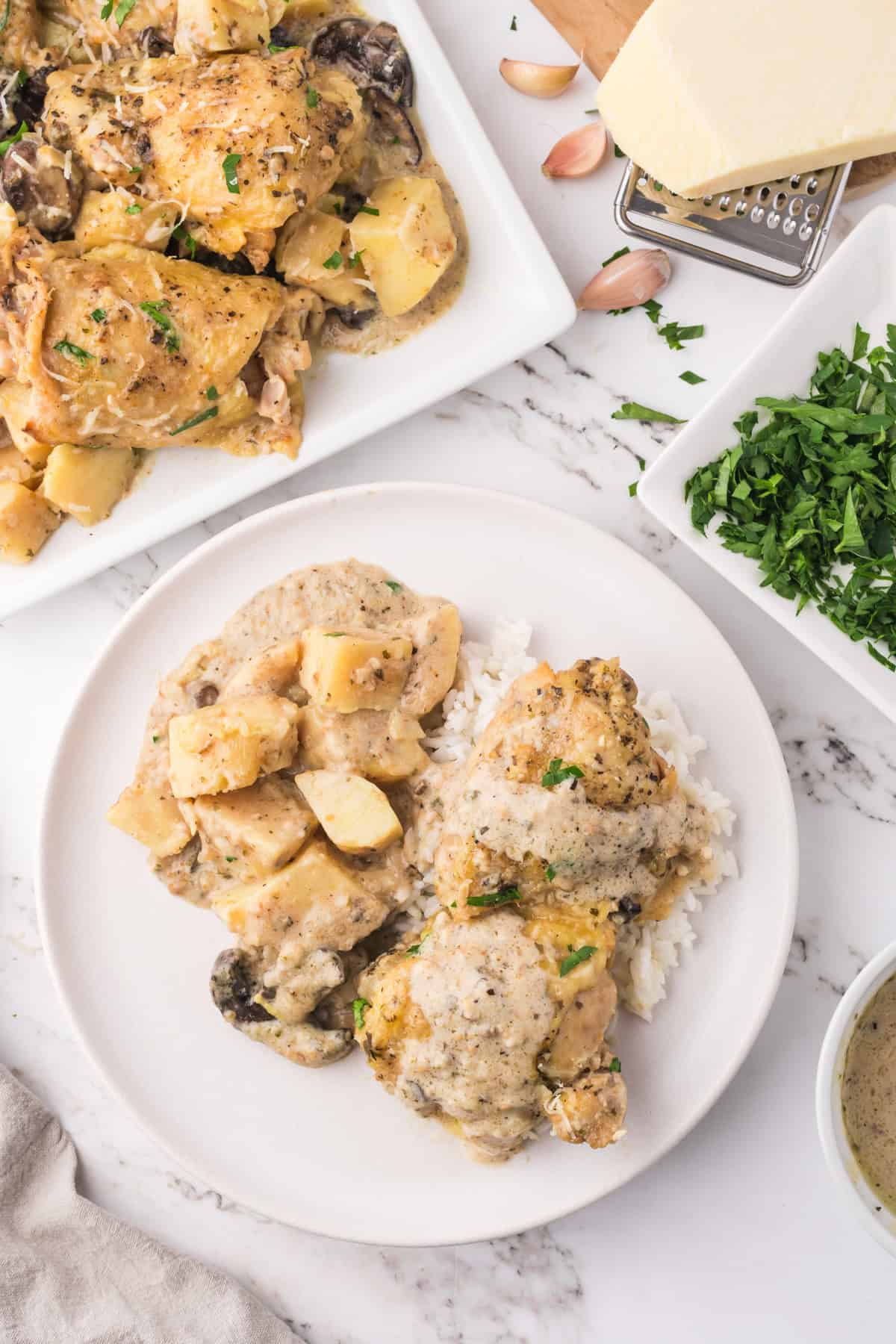 An overhead image of a serving of slow cooker garlic parmesan chicken on a plate.