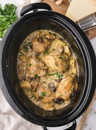 An overhead image of slow cooker garlic parmesan chicken in the slow cooker.