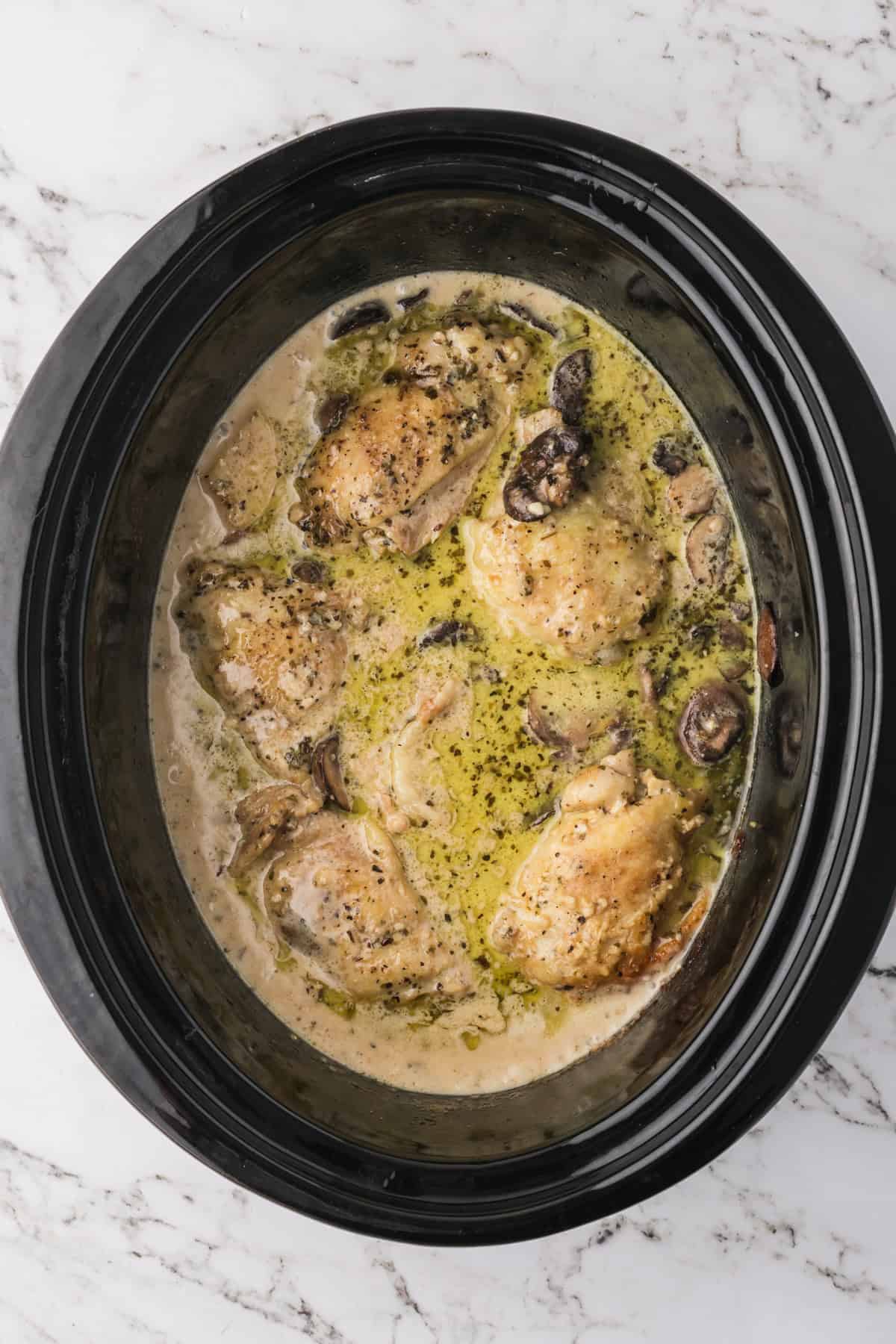 Finished slow cooker garlic parmesan chicken in a crock pot.