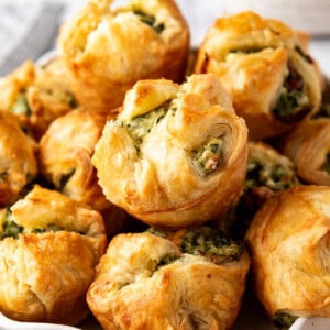 An image of spinach puffs piled in a bowl.