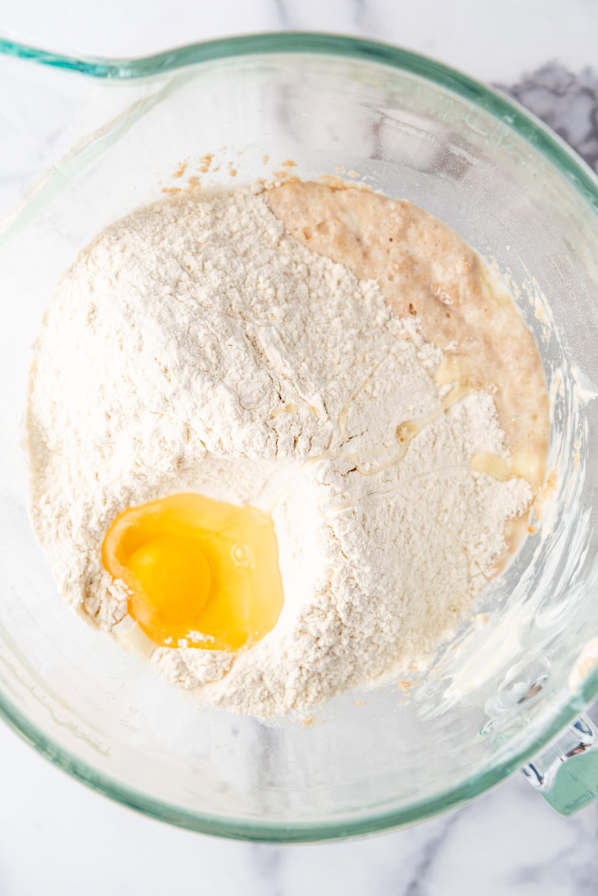 Adding flour and an egg to make roll dough.