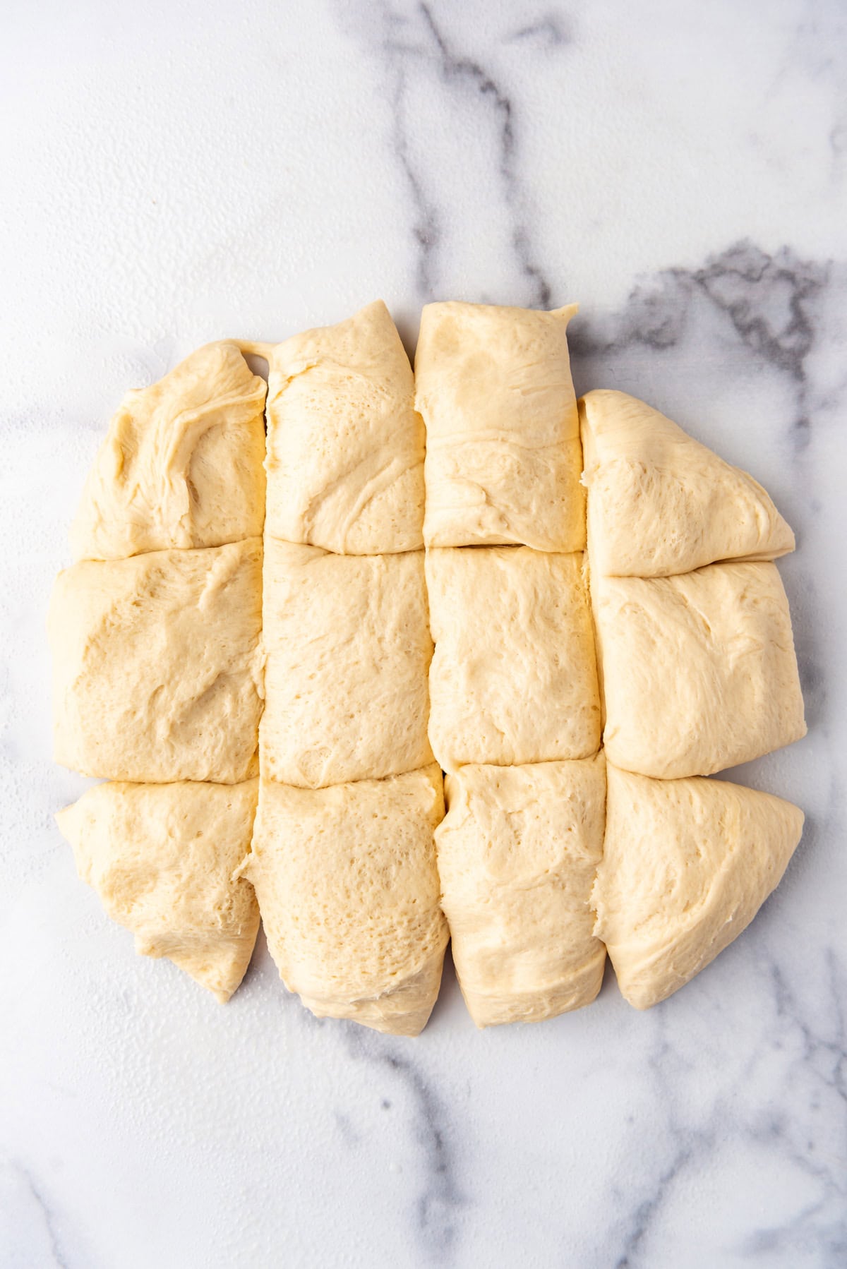 Dividing roll dough into 12 pieces.