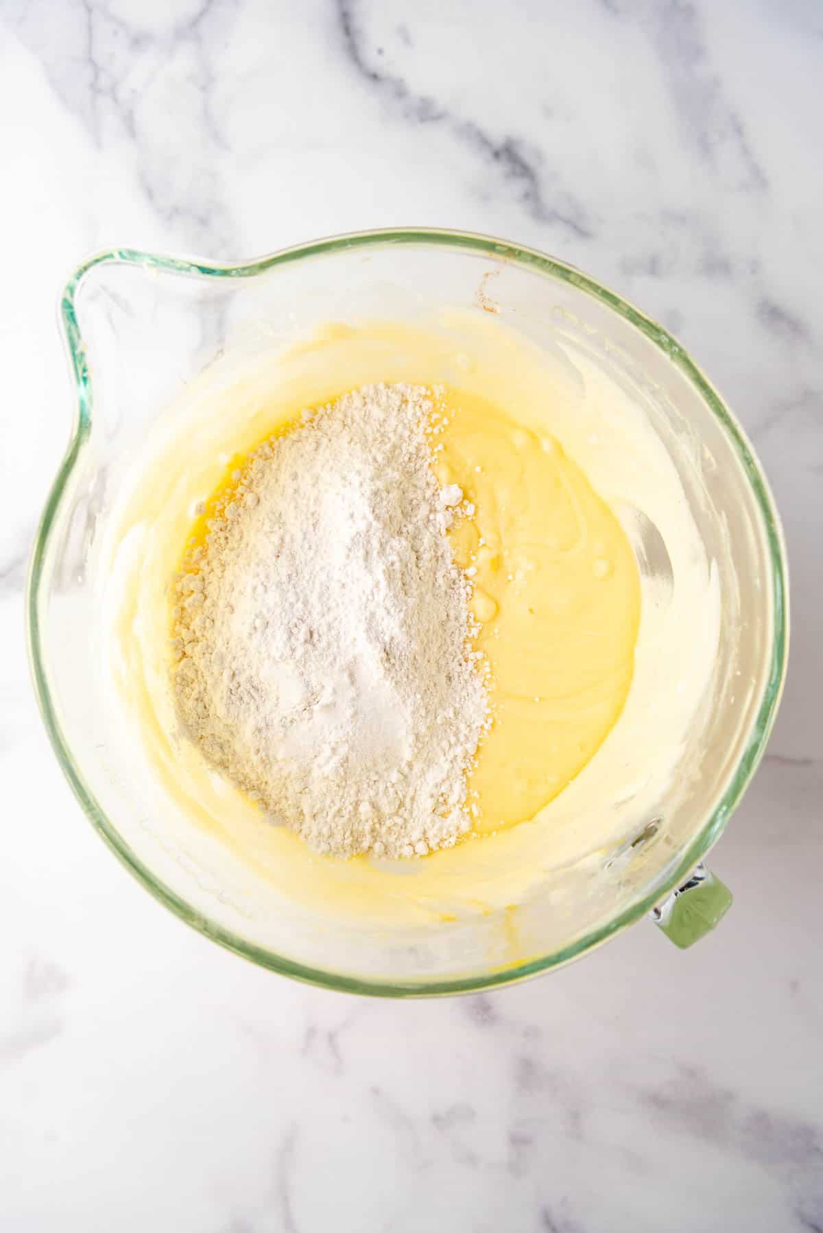 Adding dry ingredients to pound cake batter.