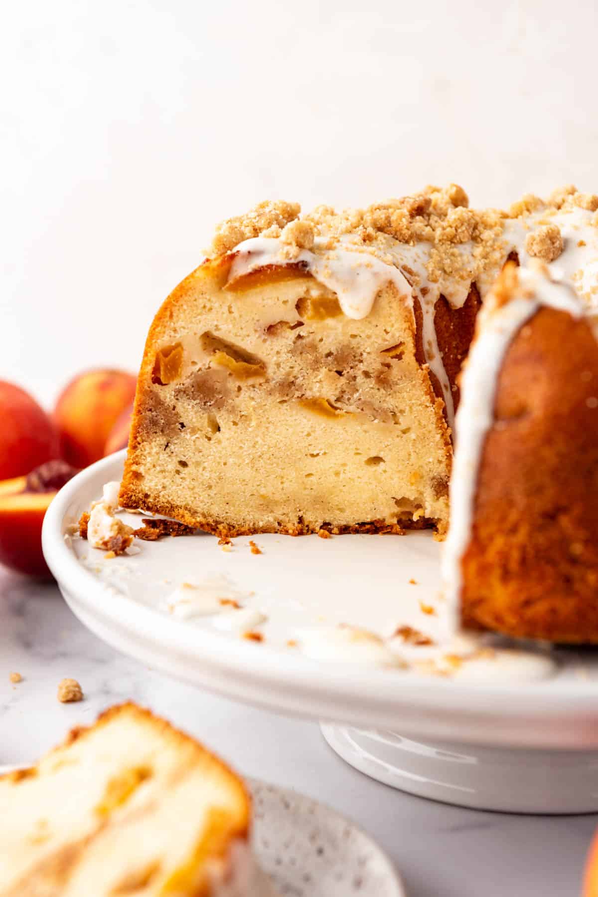 A side view of a cross section of a peach bundt cake.