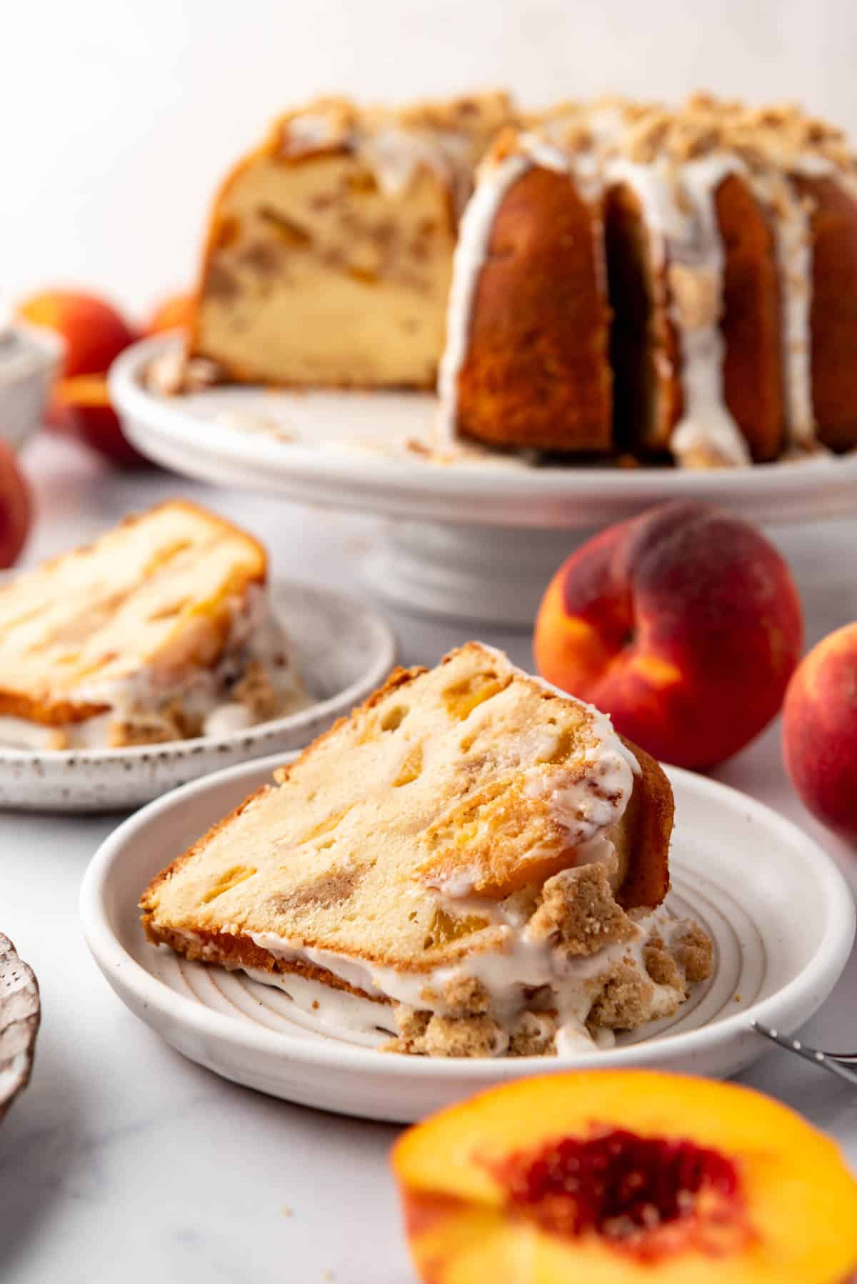 A slice of peach cobbler pound cake on a plate.