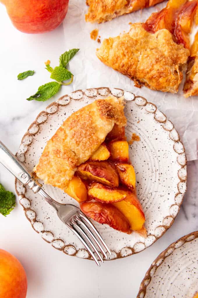 One slice of peach galette on a plate.