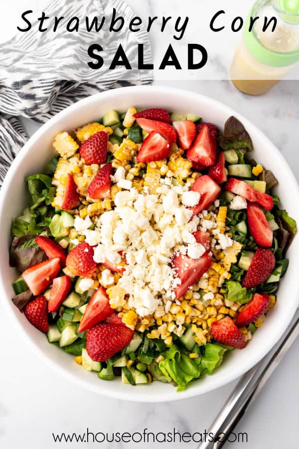 An overhead image of a salad with strawberries, corn, and feta cheese with text overlay.