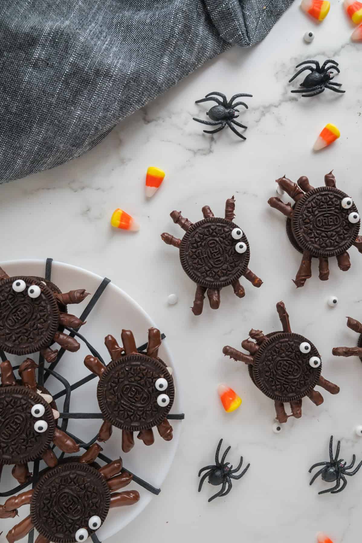 An image of Oreo spiders with candy corn scattered around.