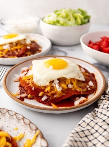 An image of New Mexico stacked enchiladas with a fried egg on top.