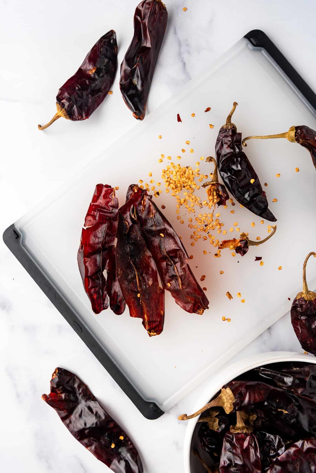 Removing seeds from dried chilis.