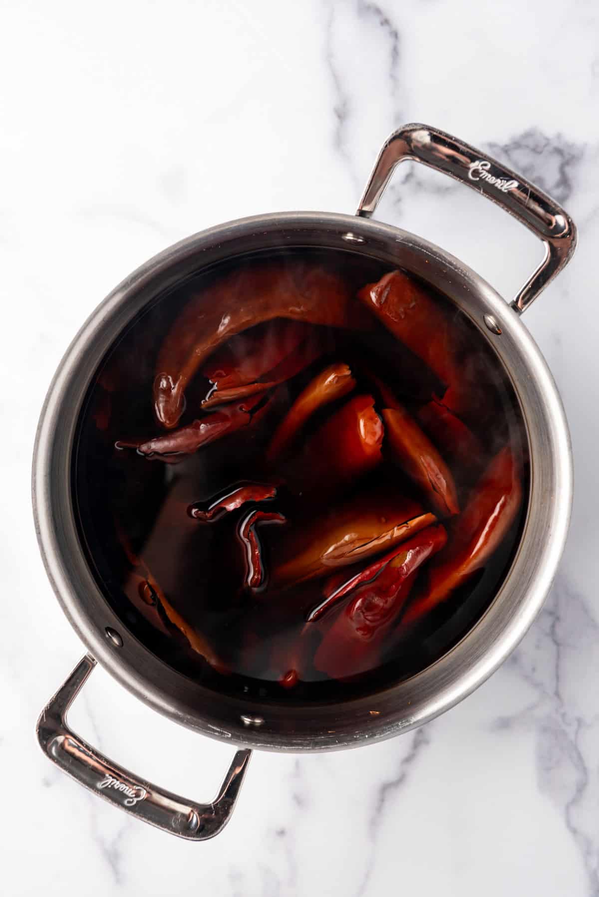 Soaking chilis in water in a large pot.