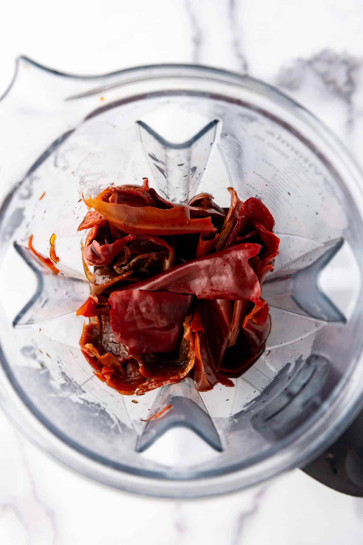 Rehydrated chilis added to a blender.