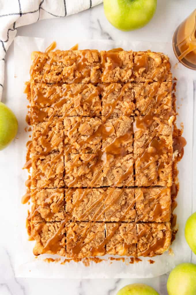 Overhead view of baked Caramel Apple Cheesecake Bars removed from the pan and sliced.