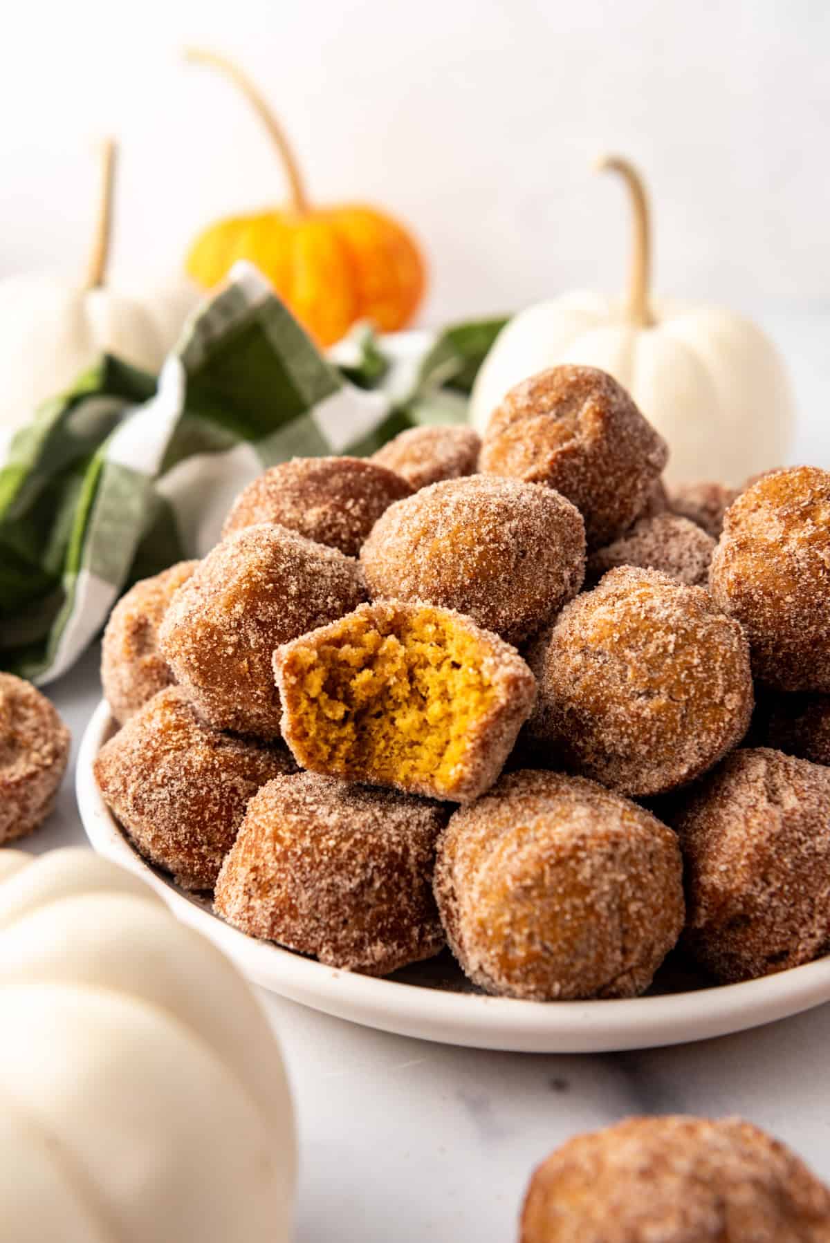 An image of pumpkin donut muffins on a plate.