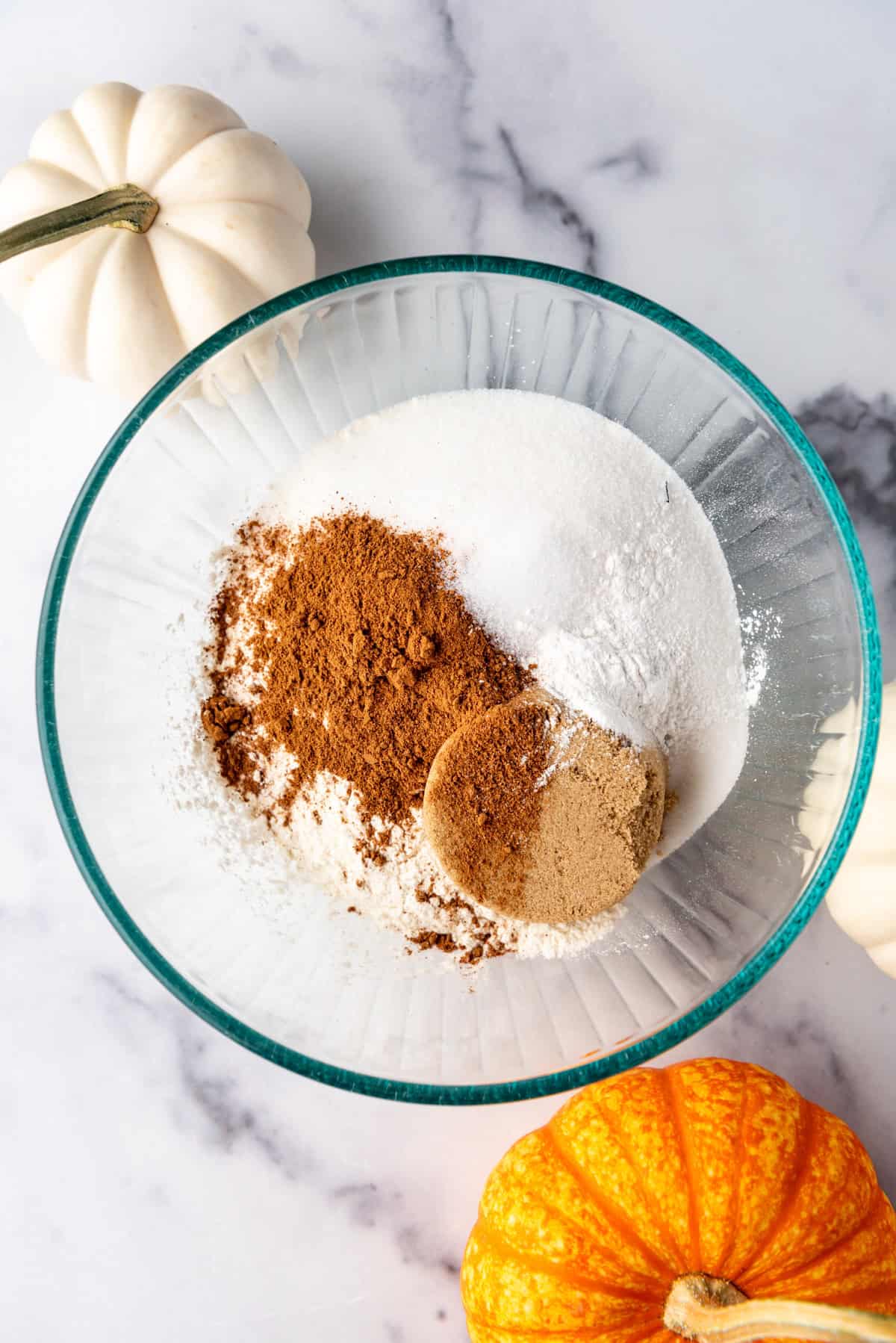 Combining dry ingredients in a mixing bowl.