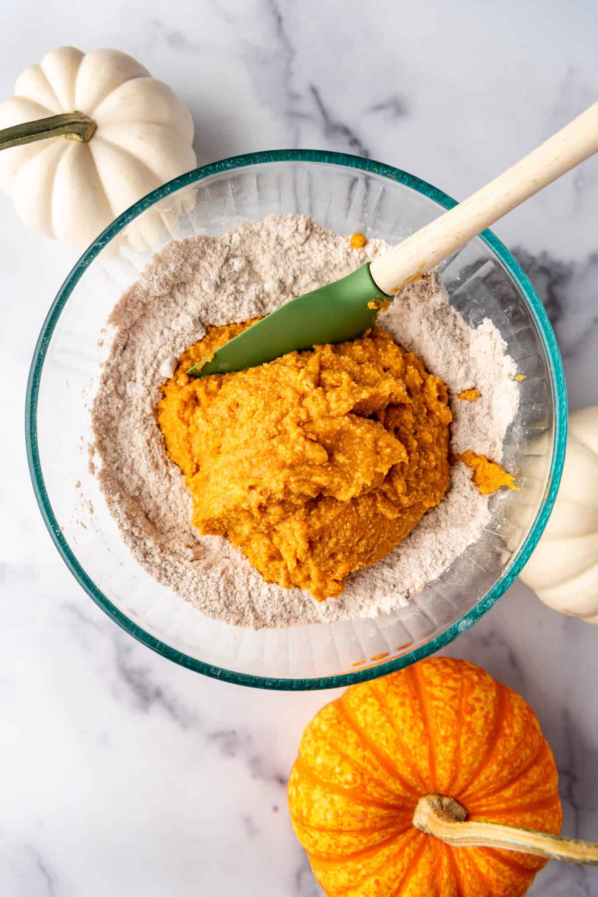 Adding wet ingredients to dry ingredients in a bowl.